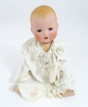 Toy: An Armand Marseille doll with bisque head, blinking eyes, two front teeth, painted features and