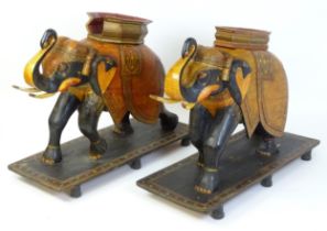 Two large Kashmir wooden models of elephants with polychrome decoration raised on rectangular bases.