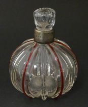 An early 20thC glass scent / perfume bottle with red glass detail and silver collar hallmarked