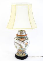 A 20thC table lamp the base formed from an Oriental vase and cover with bird and flower