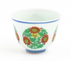 A Chinese wine cup decorated with floral roundels. Character marks under. Approx. 1 3/4" high Please