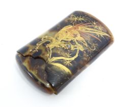 A Japanese faux tortoiseshell card case with sliding cover, decorated with red lacquered and gilt