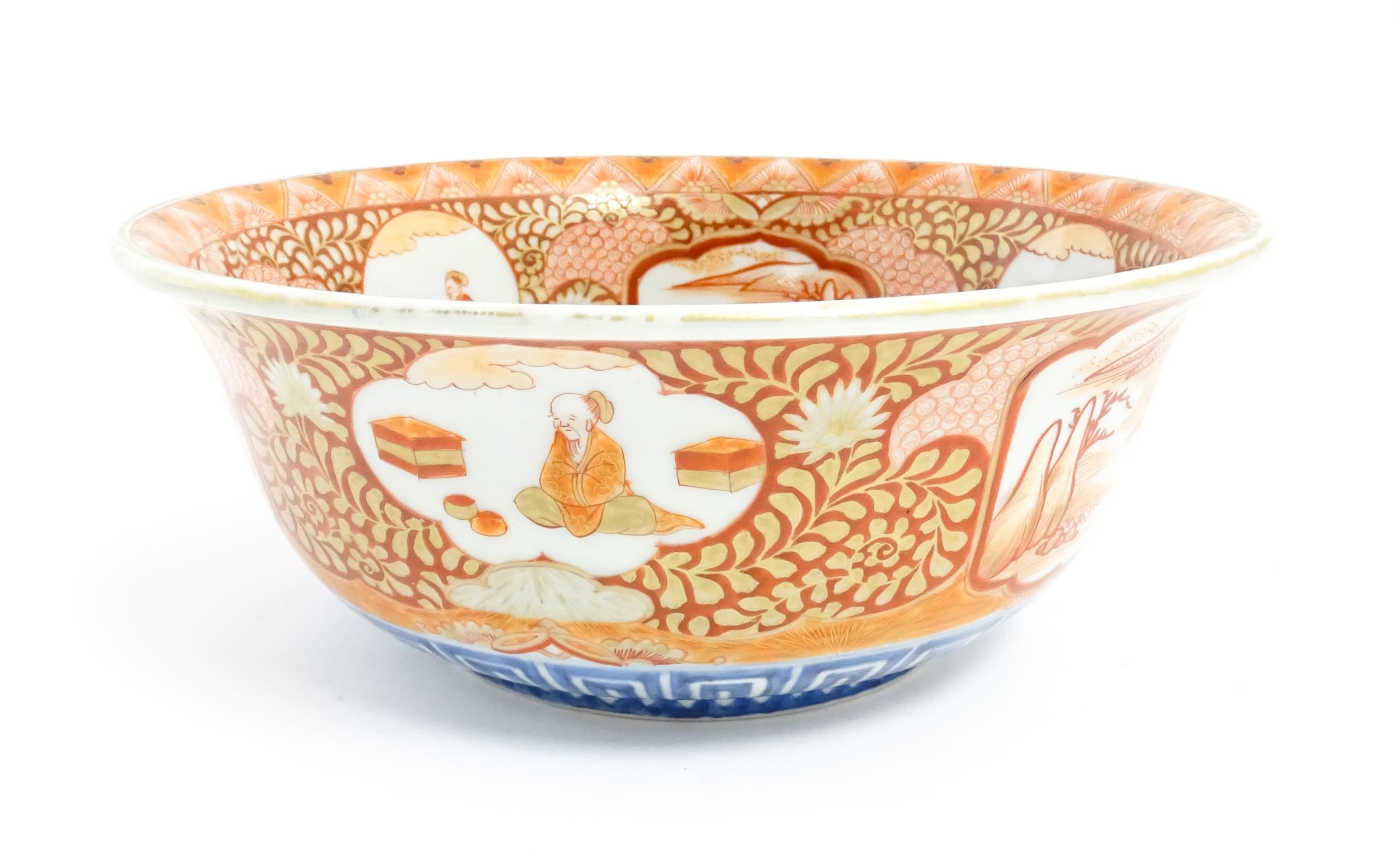 An Oriental bowl decorated in the Kutani palette with central dragon motif, the sides with landscape
