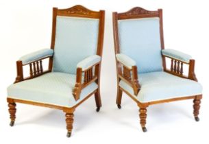 A his & hers pair of late 19thC / early 20thC walnut armchairs, the frames having shaped and