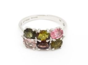 A 9ct white gold ring set with diamonds and various coloured stones. Ring size approx. L Please Note