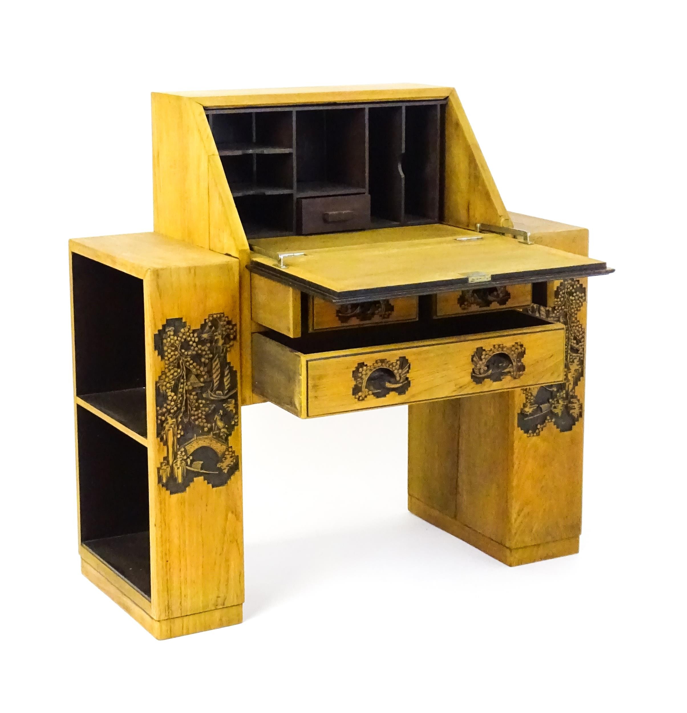 An early / mid 20thC Teak bureau accompanied by a stool, with carved oriental scenes to the front, - Image 2 of 12