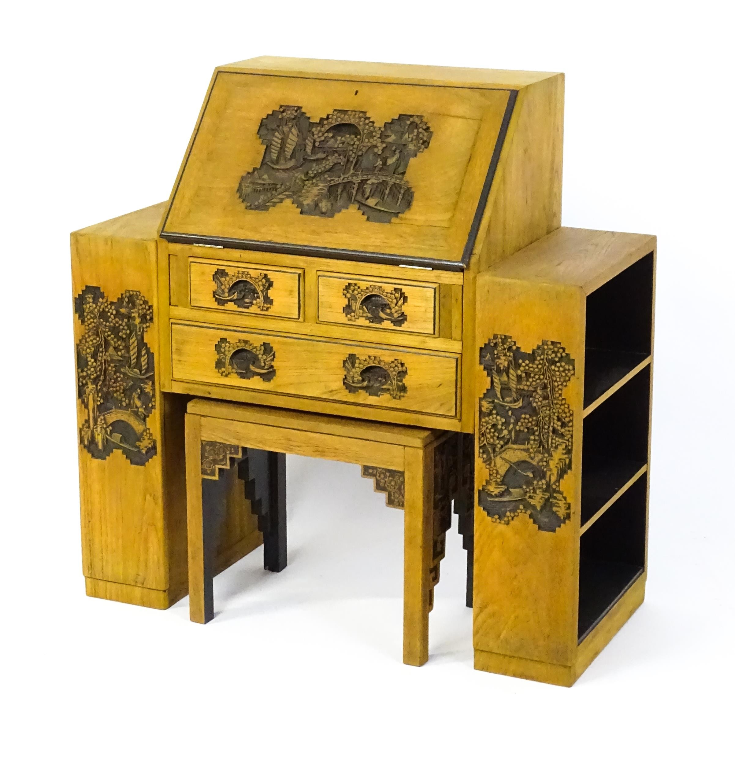 An early / mid 20thC Teak bureau accompanied by a stool, with carved oriental scenes to the front, - Image 11 of 12