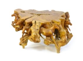A mid 20thC root carved coffee table, with galloping horses populating the exterior of the table and