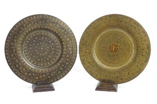 Two Indian brass chargers, one with engraved floral and foliate decoration. Together with two carved