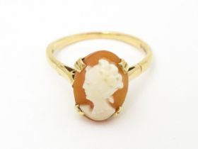 A 9ct gold ring set with cameo. Ring size approx. O. Please Note - we do not make reference to the