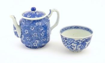 A Chinese blue and white teapot decorated with prunus blossom. Together with a Chinese blue and