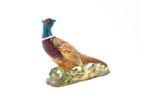 A Beswick model of a pheasant, model no. 1225. Marked under. Approx. 9 3/4" long Please Note - we do