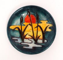 A small Moorcroft plate decorated in the Reeds at Sunset pattern. Marked under. Approx. 4 3/4"