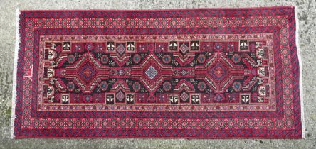 Carpet / Rug : A North east Persian meshed Belouch rug with geometric motifs and banded borders with
