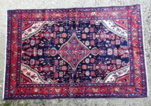 Carpet / Rug : A North west Persian Nahawand rug, the blue and red grounds with floral and foliate