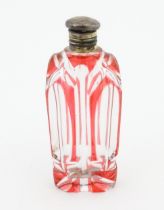 A Bohemian glass scent / perfume bottle with red detail and a Continental silver gilt lid. Approx. 3