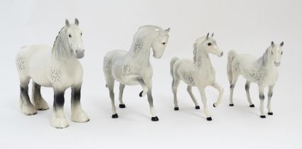 Four Beswick models of horses in dapple grey to include a head tucked leg up no. 1549, shire mare
