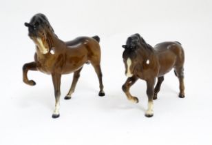 Two Beswick models of horses to include a brown horse with head tucked and leg up, model no. 1549,