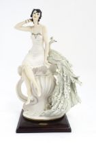 An Italian Florence figure designed by Giuseppe Armani titled Garden Delight, depicting a seated