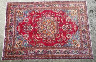 Carpet / Rug : A North East Persian Meshed carpet, the red ground with central medallion having
