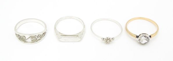 4 assorted white metal and yellow metal rings (4) Please Note - we do not make reference to the