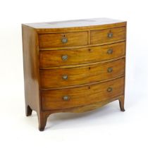 A late 18thC / early 19thC mahogany bow fronted chest of drawers with two short over three long
