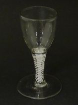 An 18thC funnel bowl wine glass with opaque twist stem. Approx. 4 3/4" high Please Note - we do