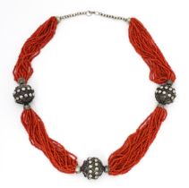 A coral necklace of 23 strands with bead spacers. Approx. 26" long Please Note - we do not make