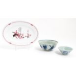 Three Oriental items comprising a blue and white bowl decorated with the eight immortals, a sake