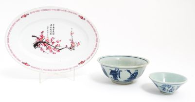 Three Oriental items comprising a blue and white bowl decorated with the eight immortals, a sake