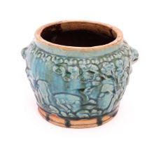 A Shiwan style vase with a blue / green glaze and twin mask handles, the body decorated in relief