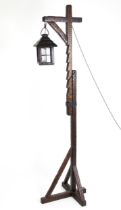 An Arts & Crafts style standard lamp of adjustable height with lantern formed shade. Approx. 73"
