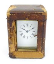 A brass carriage clock with French movement by Duverdry & Bloquel, the white enamel dial with