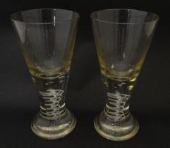 A pair of drinking glasses with twist and bubble detail to stems. Approx. 7 3/4" high (2) Please