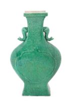 A Chinese vase of shaped form with twin elephant head handles with a green crackle glaze. Approx.