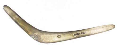 A silver model of a boomerang, hallmarked London 1911, maker Asprey & Co. Ltd. Approx. 7" long