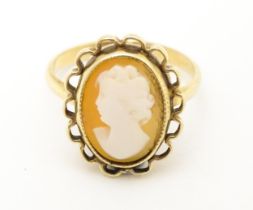 A 9ct gold ring set with central cameo. Ring size approx. M Please Note - we do not make reference