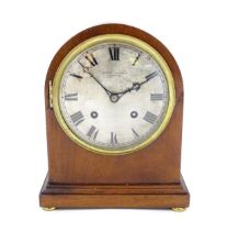 A mahogany cased mantle clock, the silvered dial with roman numerals and signed Robert Sawers