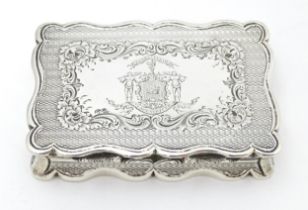A Victorian silver table snuff box with engine turned decoration and engraved crest to lid opening