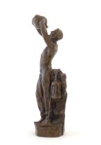 A 20thC cast sculpture after Richard Aurili, depicting a miner drinking from a water vessel, with