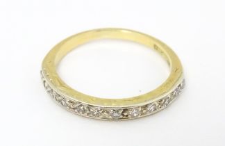 An 18ct gold and platinum half eternity ring set with diamonds. Ring size approx. N 1/2 Please