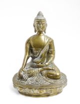 A cast brass model of a seated Buddha. Approx. 7 1/4" high Please Note - we do not make reference to