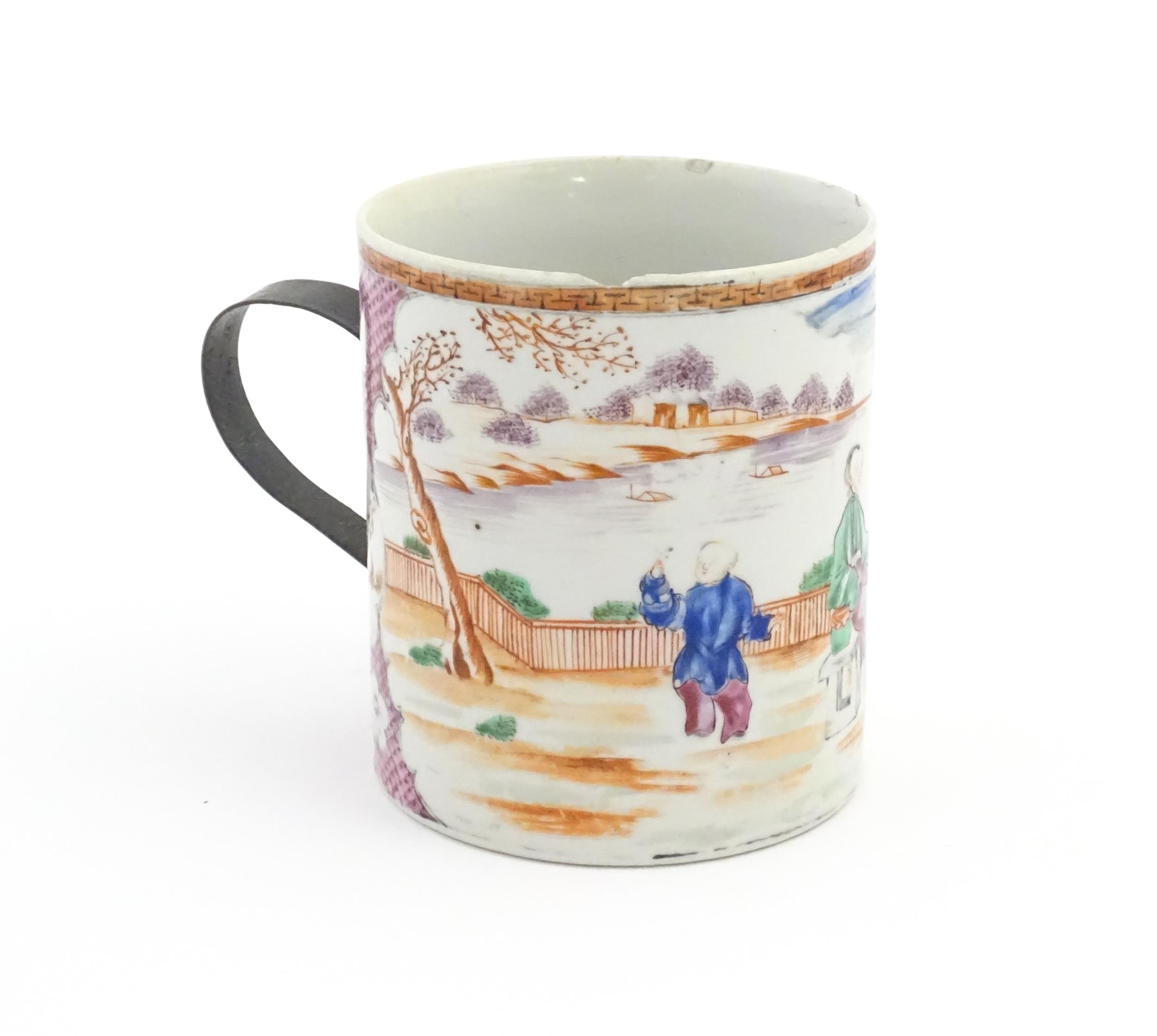 A large Chinese famille rose tankard decorated with figures in a landscape scene. Approx. 5 3/4"