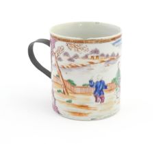 A large Chinese famille rose tankard decorated with figures in a landscape scene. Approx. 5 3/4"