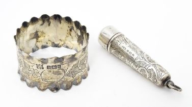 A silver napkin ring with engraved floral and foliate decoration hallmarked Sheffield 1902, maker