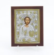 A 20thC Russian icon depicting Jesus Christ within an embossed surround bordered by fruiting vine