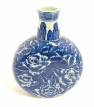 A Chinese blue and white moon vase with floral and foliate decoration. Approx. 10 1/4" high Please