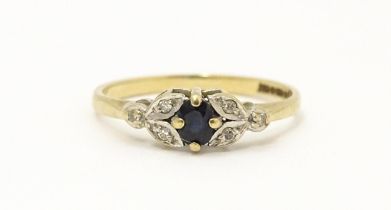 A 9ct gold ring set with central spinel flanked by diamonds. Ring size approx. J 1/2 Please Note -
