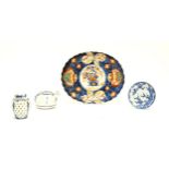 Four assorted Oriental items comprising a Japanese dish of oval form decorated in the Imari