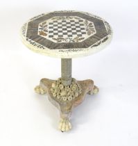 A marble games table / occasional table with a circular top and inlaid marble decoration.